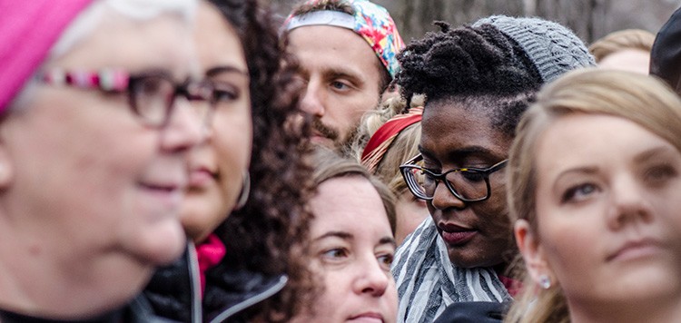 Photograph of a crowd of people with one man in focus
