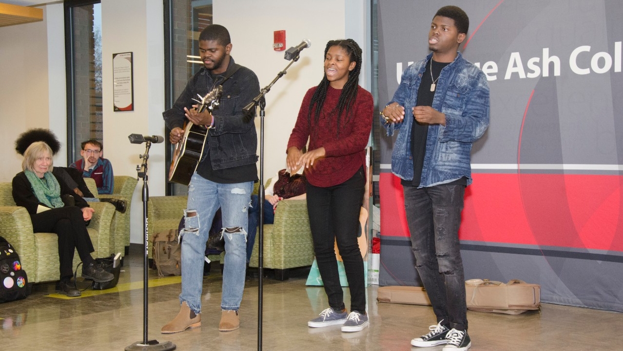 Students preforming a song at a Poetry Café event 