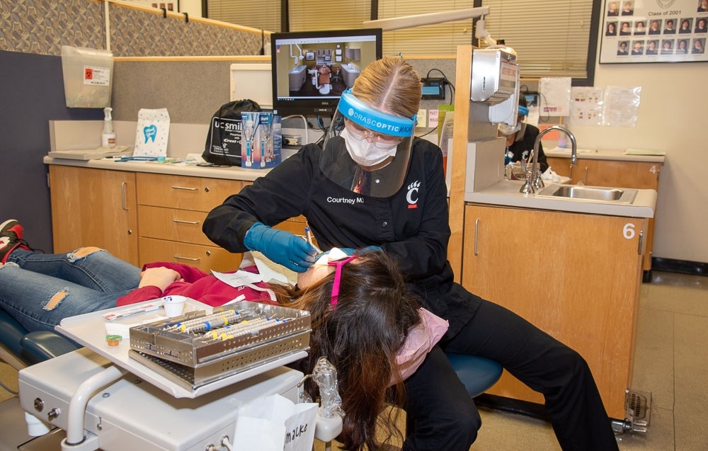 Dental Hygiene student working with child in UC Smiles Program