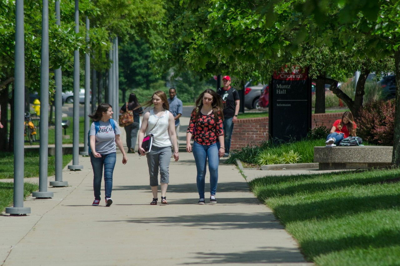 Three students walking on campus