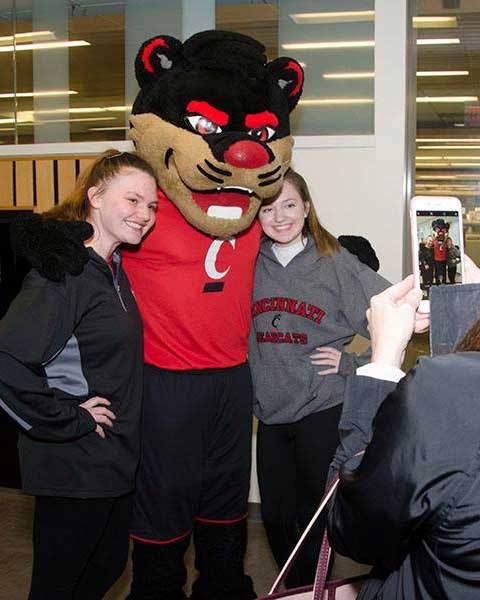Bearcat mascot with students at open house event