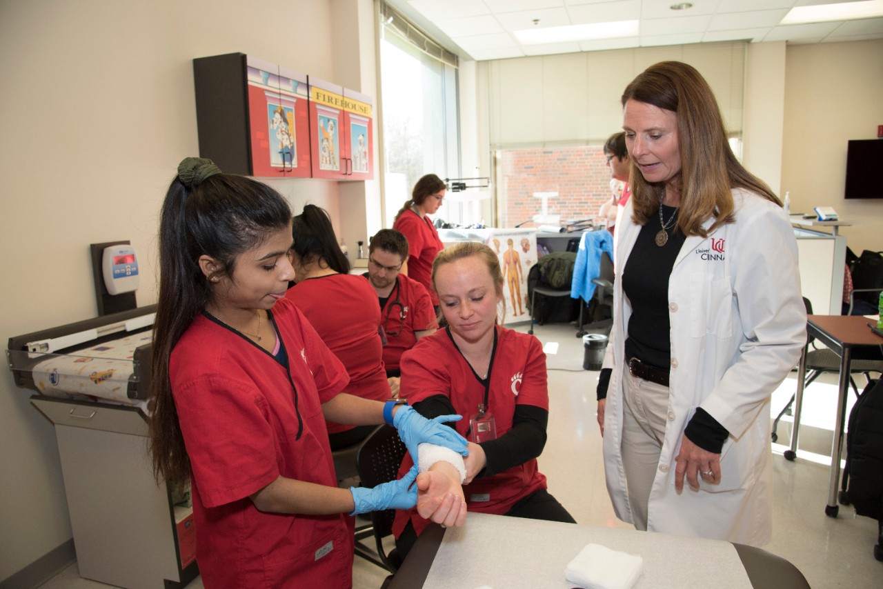 medical assisting students working in a lab with a professor