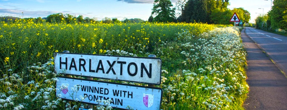 Harlaxton signpost in a field