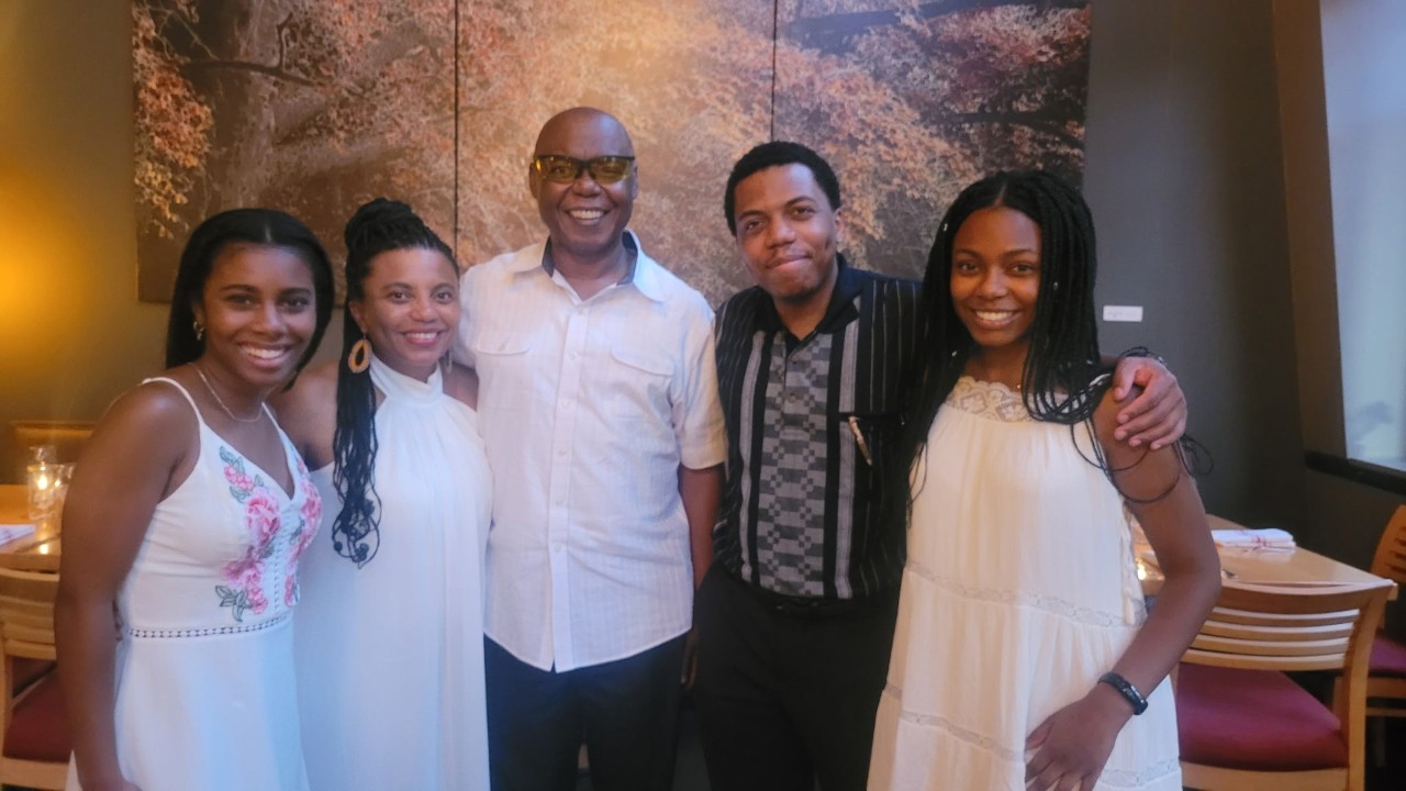 family of five smiling for camera