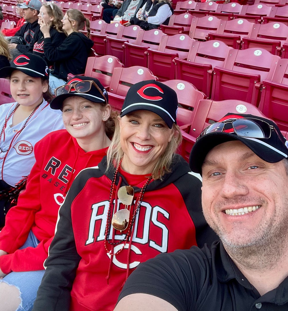 family of four people at Reds game