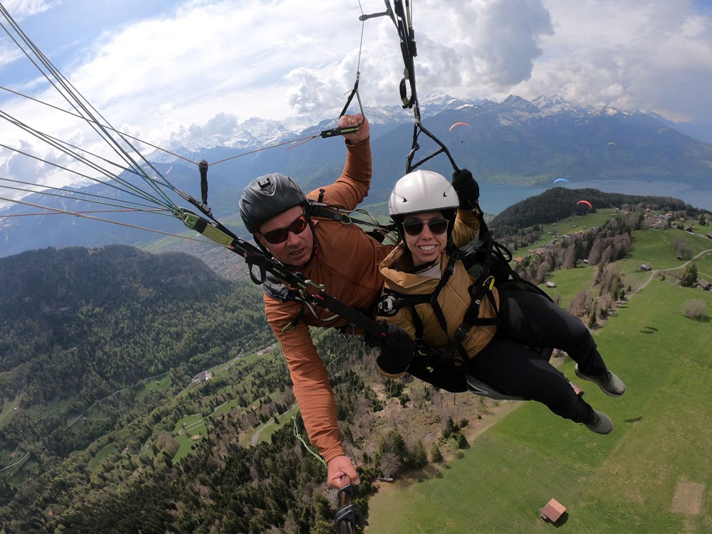 Stella paragliding over the Swiss Alps with her guide.