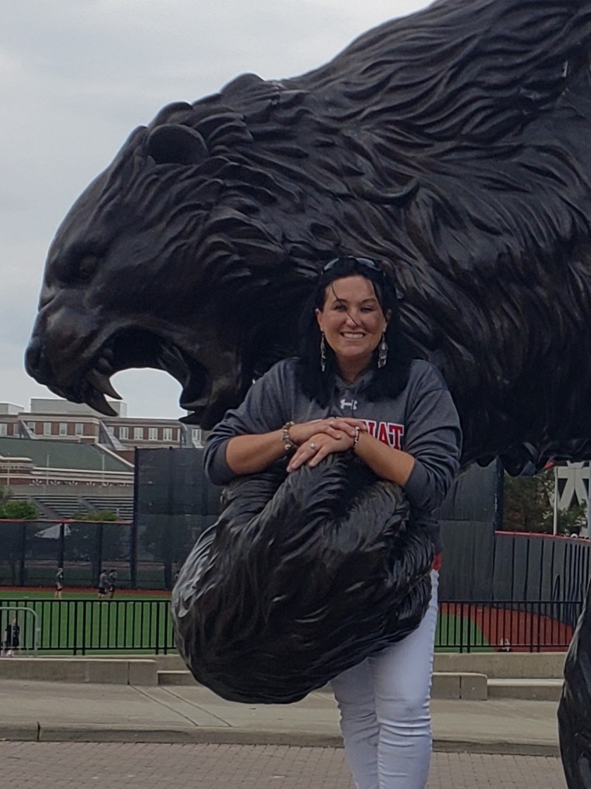 Annette Ballinger posing by bearcat statue