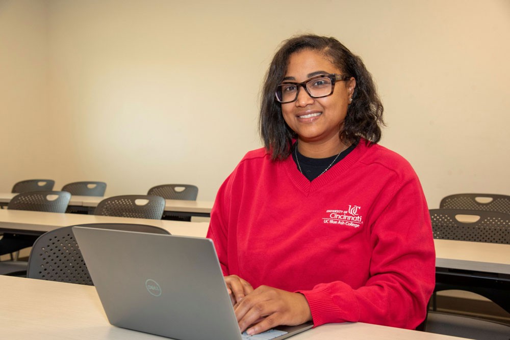 Valerie Lewis in classroom with laptop