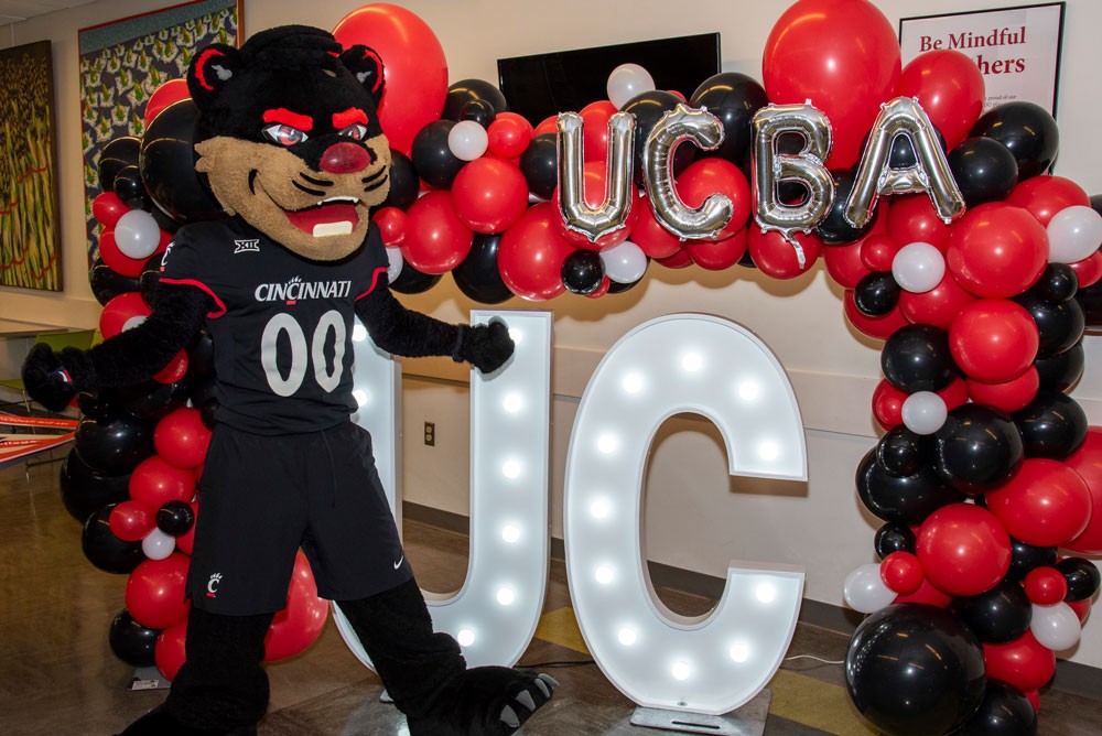 bearcat mascot in front of UC balloons