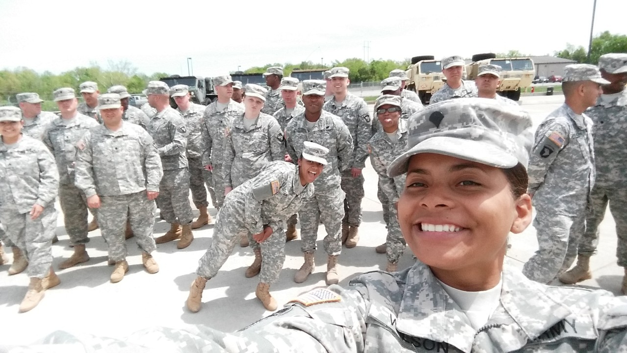 Tabitha Rios taking selfie with group of soldiers