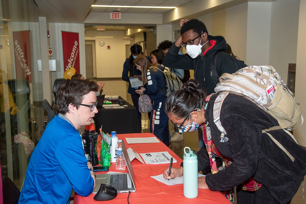 Students meeting with potential employer at career fair