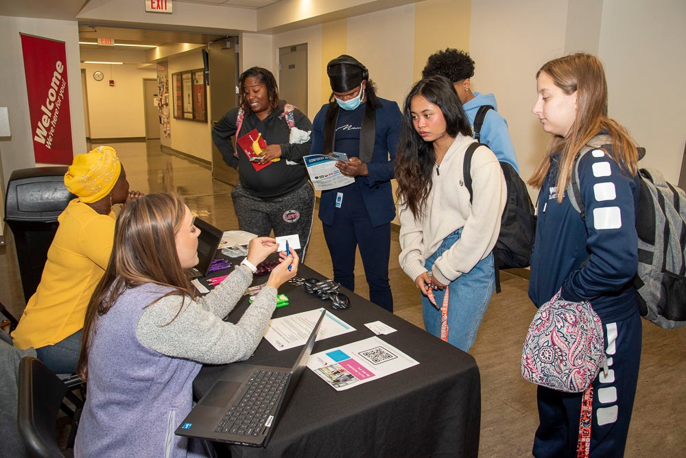 Students meeting with potential employer at career fair